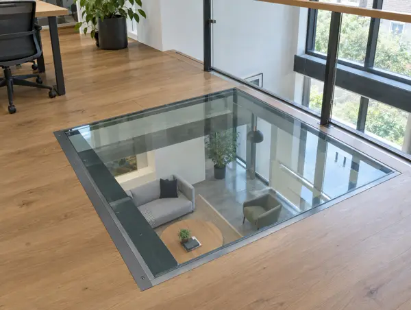 Walk-on glass floor panel set into a timber mezzanine floor, looking down to the room below